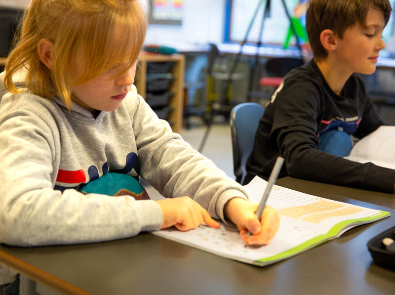 Two boys in school focusing with an inmu8311